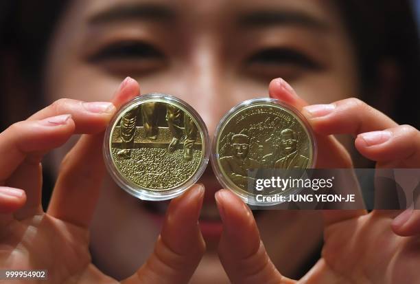 South Korean model shows medallions commemorating the historic inter-Korean summit between Moon Jae-in and Kim Jong Un during an unveiling ceremony...