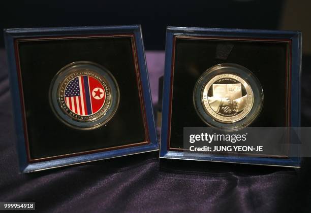 The second edition of medallions commemorating the historic US-North Korea summit are displayed during an unveiling ceremony at a sales company in...