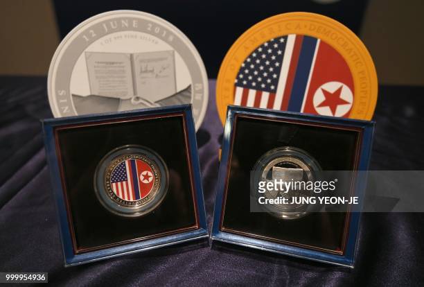 The second edition of medallions commemorating the historic US-North Korea summit are displayed during an unveiling ceremony at a sales company in...