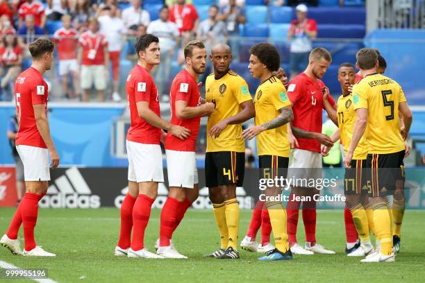 Harry Maguire and Harry Kane of England with Vincent Kompany and Axel Witsel of Belgium during the 2018 FIFA World Cup Russia 3rd Place Playoff match...