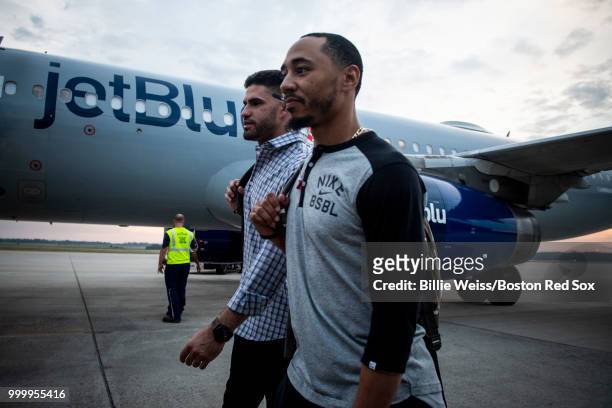 Mookie Betts and J.D. Martinez of the Boston Red Sox walk outside of the plane during a team charter flight to Washington, DC for the 2018 Major...