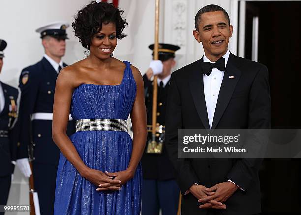 President Barack Obama and his wife first lady Michelle Obama wait to greet Mexican President Felipe Calderon and his wife Margarita Zavala as they...