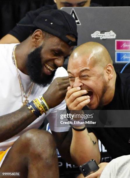 LeBron James of the Los Angeles Lakers and his friend Paul Rivera share a laugh as they attend a quarterfinal game of the 2018 NBA Summer League...