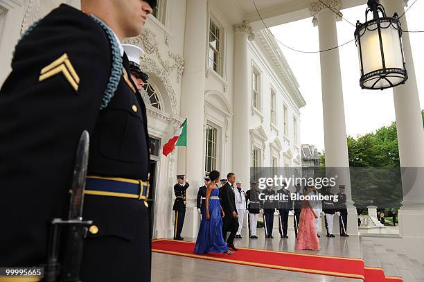 President Barack Obama and First Lady Michelle Obama walk out to the North Portico of the White House to greet Mexican President Felipe Calderon and...