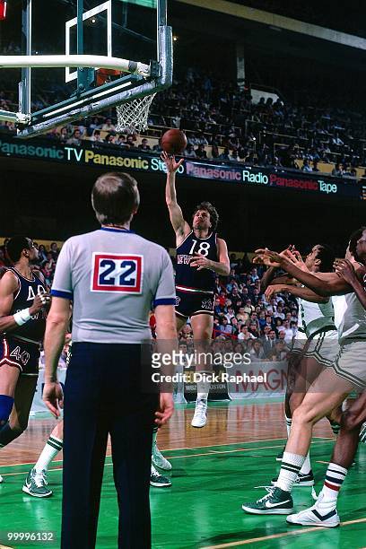 Ernie Grunfeld of the New York Knicks shoots against the Boston Celtics during a game played in 1983 at the Boston Garden in Boston, Massachusetts....