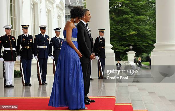 President Barack Obama and first lady Michelle Obama wait to welcome Mexican President Felipe Calderon and first lady Margarita Zavala on the North...