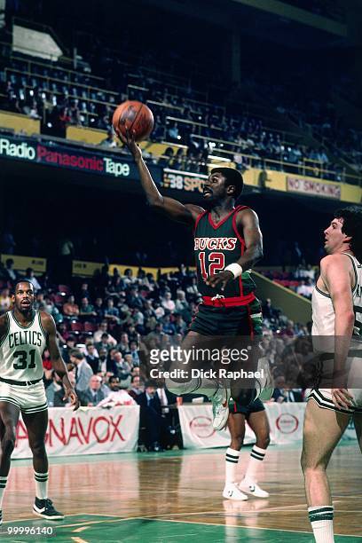 Phil Ford of the Milwaukee Bucks shoots a layup against the Boston Celtics during a game played in 1983 at the Boston Garden in Boston,...