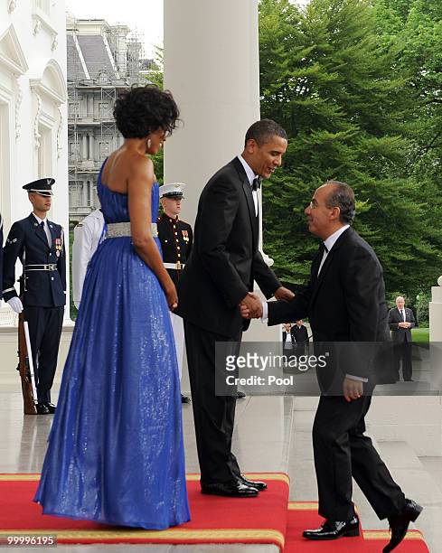 President Barack Obama shakes hands with Mexican President Felipe Calderon as he and first lady Michelle Obama welcome Calderon and first lady...