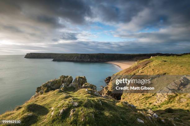 stunning, vibrant sunrise landscape image of barafundle bay on p - dyfed stock pictures, royalty-free photos & images