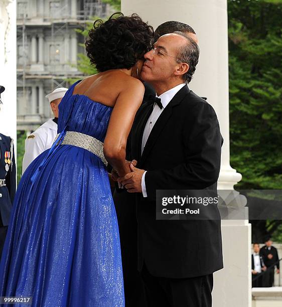 First lady Michelle Obama embraces Mexican President Felipe Calderon as she and U.S. President Barack Obama welcome Calderon and Mexican first lady...