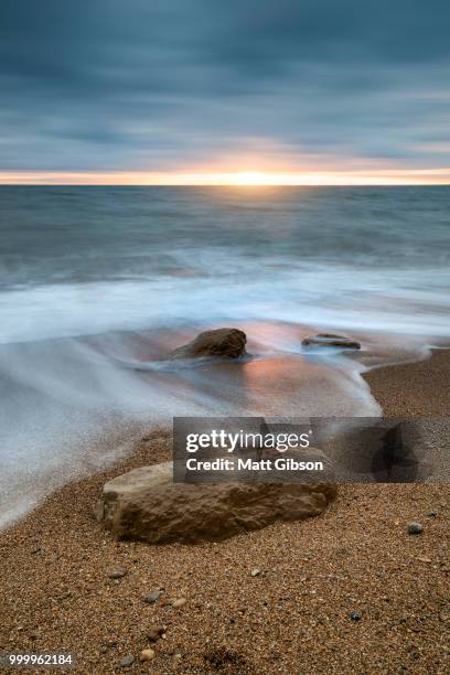 beautiful vibrant sunset landscape image of burton bradstock gol - gol stock pictures, royalty-free photos & images