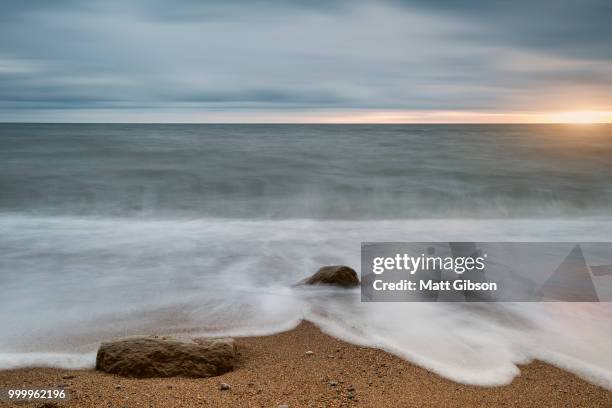 beautiful vibrant sunset landscape image of burton bradstock gol - gol stock pictures, royalty-free photos & images