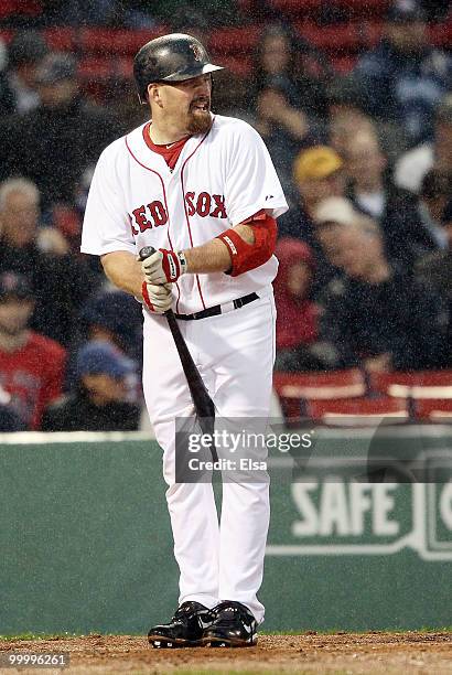 Kevin Youkilis of the Boston Red Sox wipes off his bat in the first inning against the Minnesota Twins on May 19, 2010 at Fenway Park in Boston,...