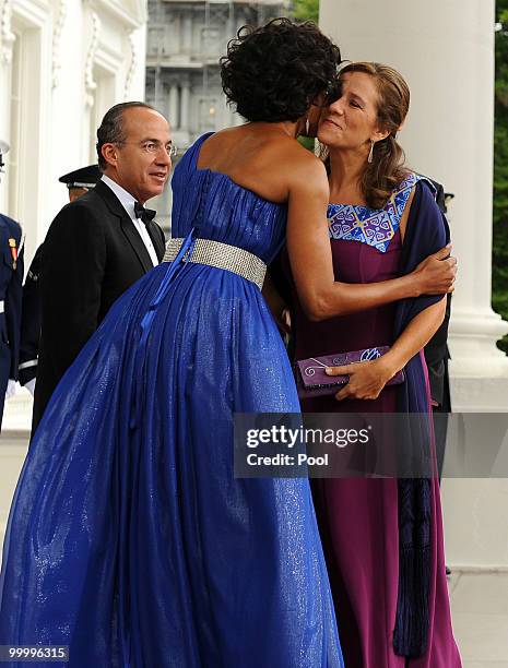 First lady Michelle Obama embraces Mexican first lady Margarita Zavala while Mexican President Felipe Calderon looks on as they arrive on the North...