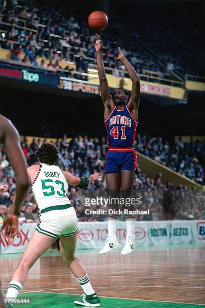 Terry Tyler of the Detroit Pistons shoots a jump shot against Rick Robey of the Boston Celtics during a game played in 1983 at the Boston Garden in...