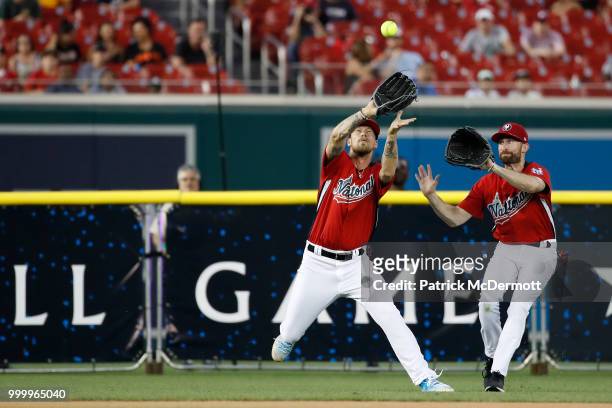 Brian Kelly catches a ball in front of Scott Rogowsky during the All-Star and Legends Celebrity Softball Game at Nationals Park on July 15, 2018 in...