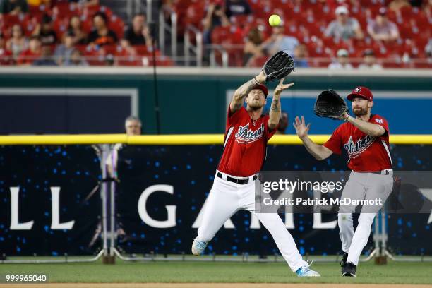 Brian Kelly catches a ball in front of Scott Rogowsky during the All-Star and Legends Celebrity Softball Game at Nationals Park on July 15, 2018 in...