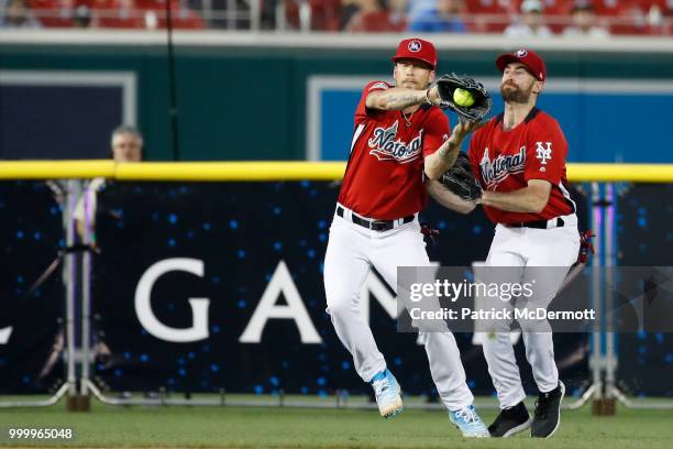 Brian Kelly catches a ball in front of Scott Rogowsky during the All-Star and Legends Celebrity Softball Game at Nationals Park on July 15, 2018 in...