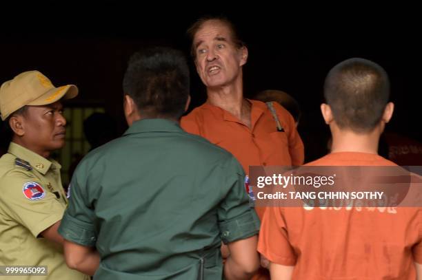 Detained Australian filmmaker James Ricketson arrives in Phnom Penh court for his continuing trial on July 16, 2018. - Ricketson was arrested in...