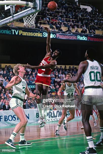 Joe Bryant of the Houston Rockets shoots against Larry Bird of the Boston Celtics during a game played in 1983 at the Boston Garden in Boston,...