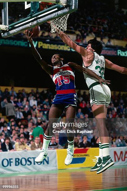 Frank Johnson of the Washington Bullets shoots a layup against Kevin McHale of the Boston Celtics during a game played in 1983 at the Boston Garden...