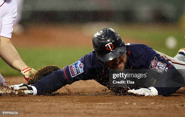 Nick Punto of the Minnesota Twins is picked off at first base in the third inning against the Boston Red Sox on May 19, 2010 at Fenway Park in...