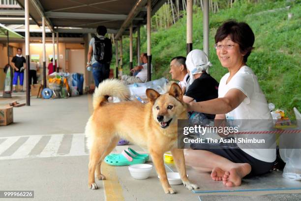 Kumiko Yamane and her dog Hana spend time at an evacuation center on July 15, 2018 in Kurashiki, Okayama, Japan. More than 100 people were treated...