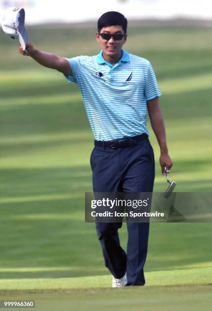 Michael Kim acknowledges the crowd as he walks down the fairway of the 18th hole during the final round of the John Deere Classic on July 15 at TPC...