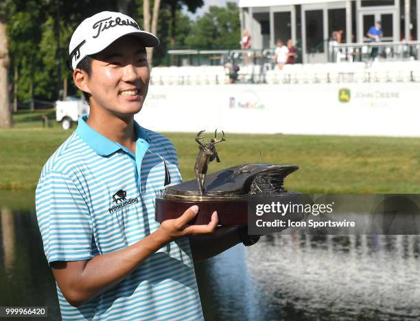 Michael Kim holds the championship trophy he won during the John Deere Classic on July 15 at TPC Deere Run, Silvis, IL.