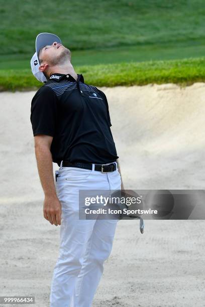 Bronson Burgoon reacts after a shot from the sand on the 18th hole during the final round of the John Deere Classic on July 15, 2018 at the TPC Deere...