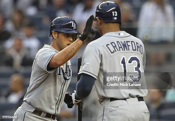 Jason Bartlett of the Tampa Bay Rays celebrates with teammate Carl Crawford after a solo home run in the first inning against the New York Yankees at...