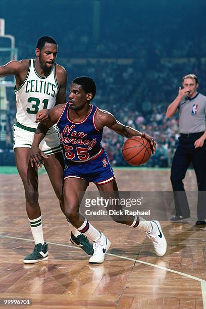 Albert King of the New Jersey Nets moves the ball against Cedric Maxwell of the Boston Celtics during a game played in 1983 at the Boston Garden in...