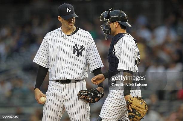 Burnett of the New York Yankees talks with Francisco Cervelli against the Tampa Bay Rays at Yankee Stadium on May 19, 2010 in the Bronx borough of...