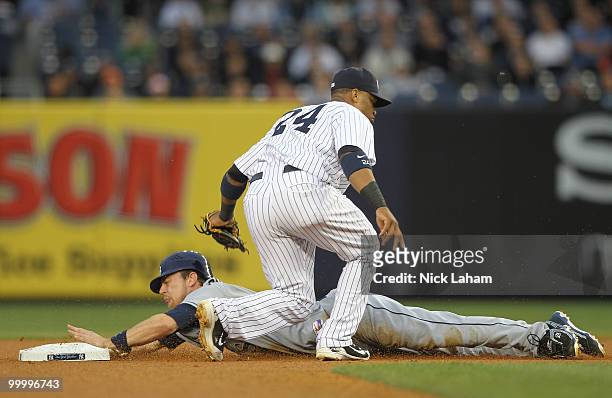 Ben Zobrist of the Tampa Bay Rays steals second under the tag of Robinson Cano of the New York Yankees at Yankee Stadium on May 19, 2010 in the Bronx...