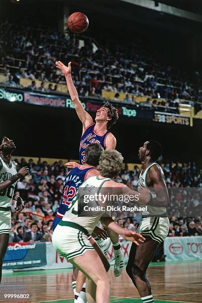 Mike O'Koren of the New Jersey Nets shoots a layup against Larry Bird of the Boston Celtics during a game played in 1983 at the Boston Garden in...