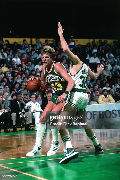 Jack Sikma of the Seattle Supersonics makes a move to the basket against Kevin McHale of the Boston Celtics during a game played in 1983 at the...