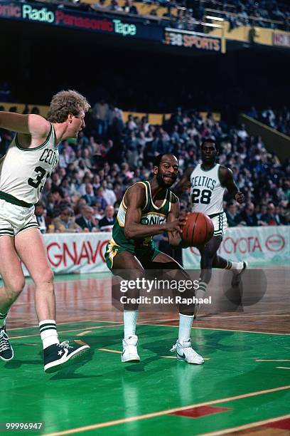 Gus Williams of the Seattle Supersonics looks to make a move against Larry Bird of the Boston Celtics during a game played in 1983 at the Boston...