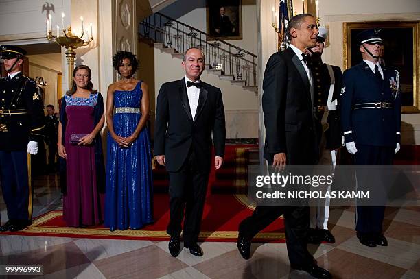 President Barack Obama, his wife Michelle Obama, Mexican President Felipe Calderon and his wife Margarita Zavala walk away after posing for pictures...