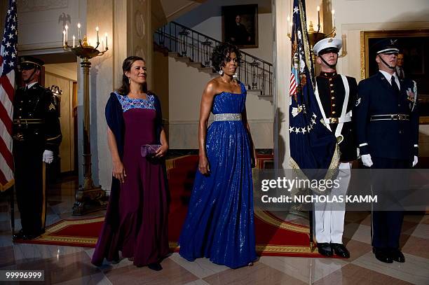 First Lady Michelle Obama and her Mexican counterpart Margarita Zavala walk away after posing for pictures at the White House before a state dinner...