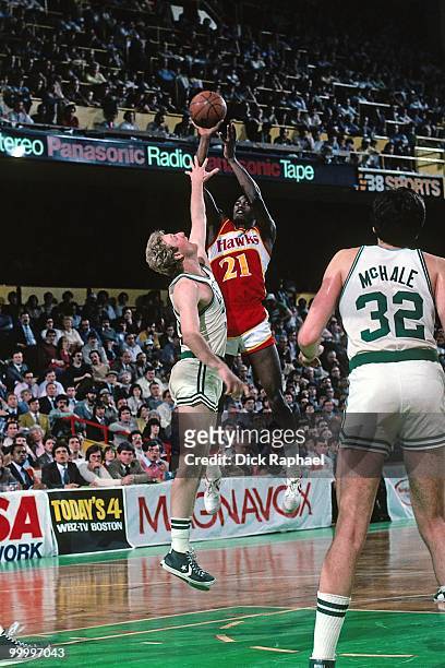 Dominique Wilkins of the Atlanta Hawks shoots against Larry Bird of the Boston Celtics during a game played in 1983 at the Boston Garden in Boston,...