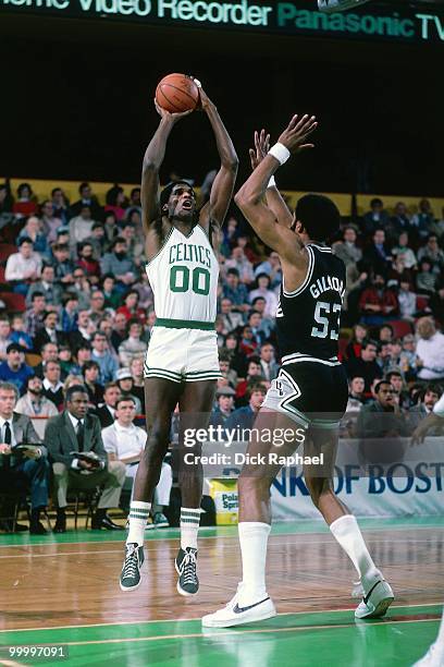 Robert Parish of the Boston Celtics shoots against Artis Gilmore of the San Antonio Spurs during a game played in 1983 at the Boston Garden in...