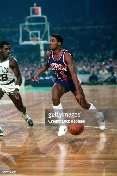 Isiah Thomas of the Detroit Pistons moves the ball up court against Quinn Buckner of the Boston Celtics during a game played in 1983 at the Boston...
