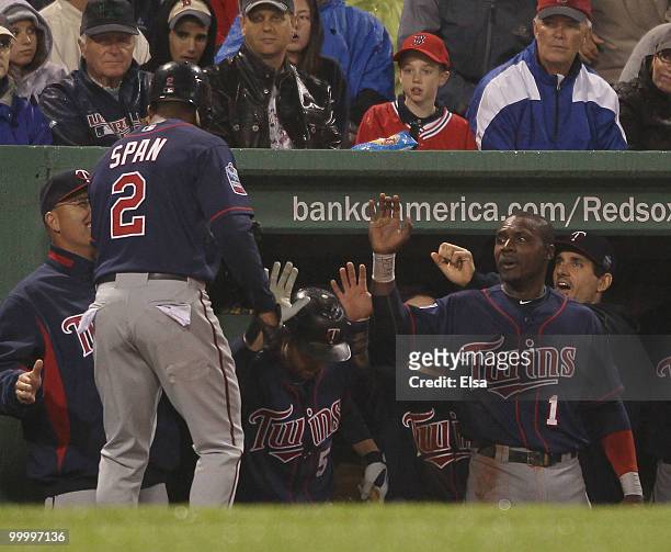 Denard Span of the Minnesota Twins is congratulated by teammate Orlando Hudson after Span was driven in by a Joe Mauer hit on May 19, 2010 at Fenway...