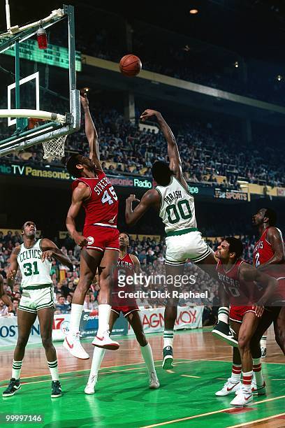 Robert Parish of the Boston Celtics shoots against Clemon Johnson of the Philadelphia 76ers during a game played in 1983 at the Boston Garden in...
