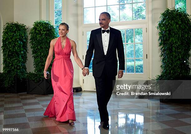 Attorney General Eric H. Holder Jr. And Dr. Sharon Malone arrive at the White House for a state dinner May 19, 2010 in Washington, DC. President...