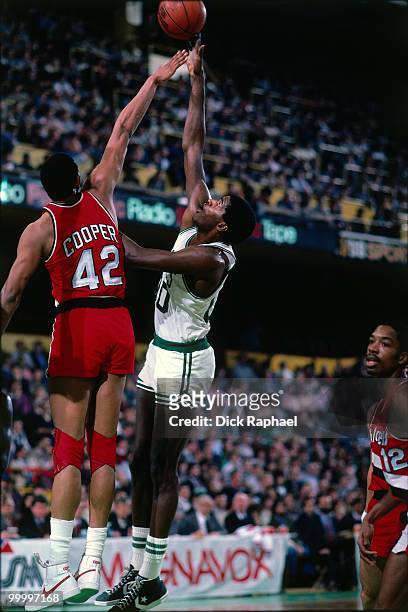 Robert Parish of the Boston Celtics shoots against Wayne Cooper of the Portland Trail Blazers during a game played in 1983 at the Boston Garden in...