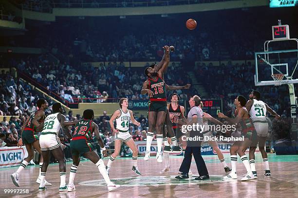 Bob Lanier of the Milwaukee Bucks battles for the jump ball against Robert Parish of the Boston Celtics during a game played in 1983 at the Boston...