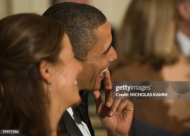 President Barack Obama and Mexican First Lady Margarita Zavala laugh as they listen to Mexican President Felipe Calderon address a state dinner at...