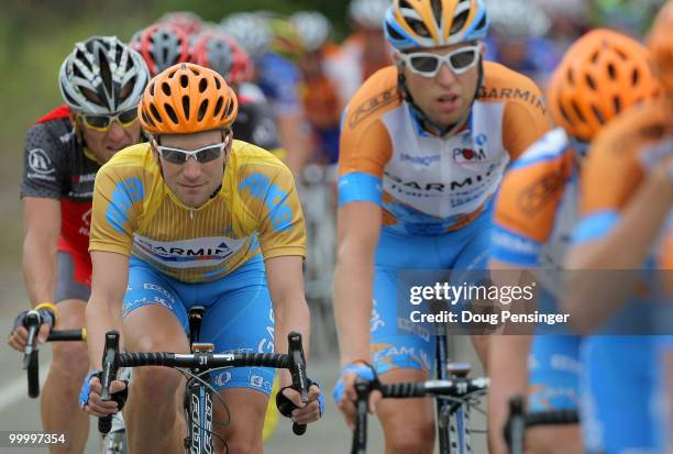 David Zabriskie of the USA and rding for Garmin-Transitions, in the race leader golden jersey, is protected by his team and shadowed by Lance...