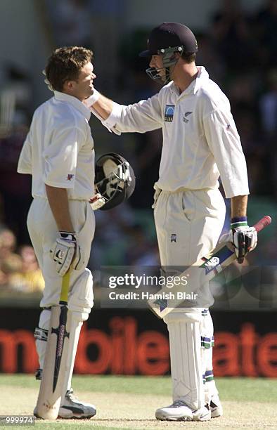 Lou Vincent of New Zealand is congratulated on his century by team mate Stephen Fleming during day one of the Third Test between Australia and New...